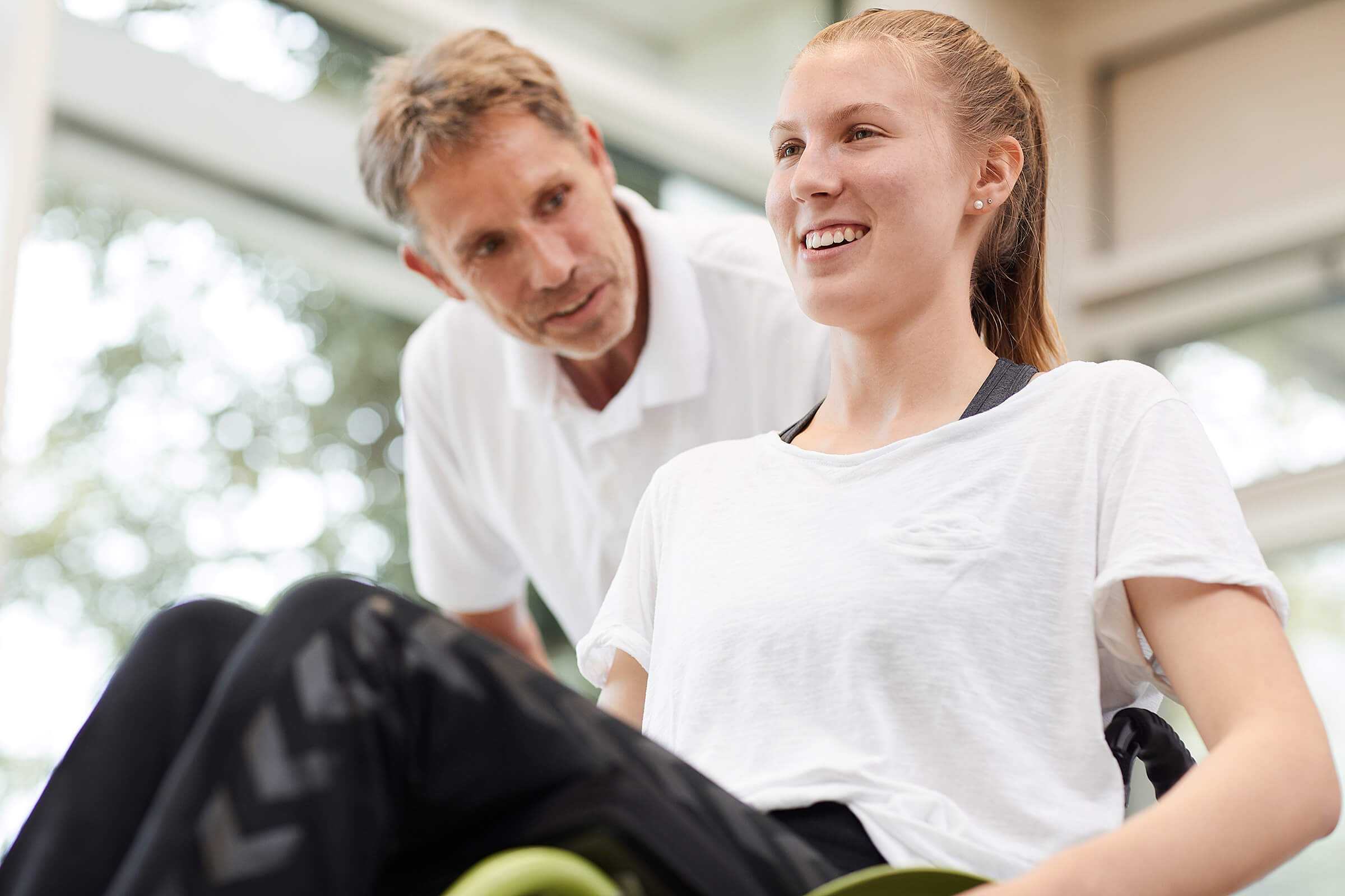 Young girl supported by her trainer